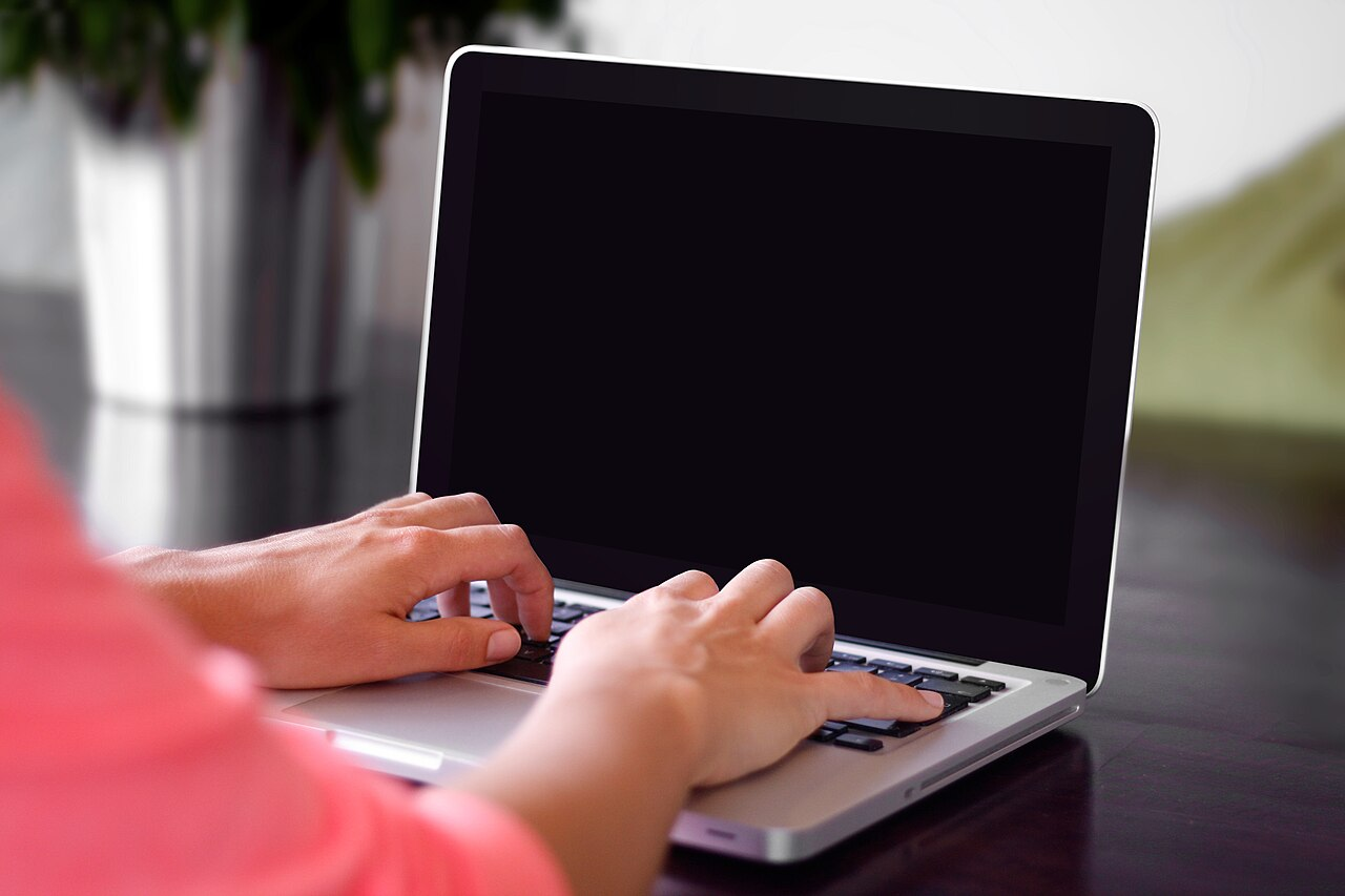 Typing on a laptop